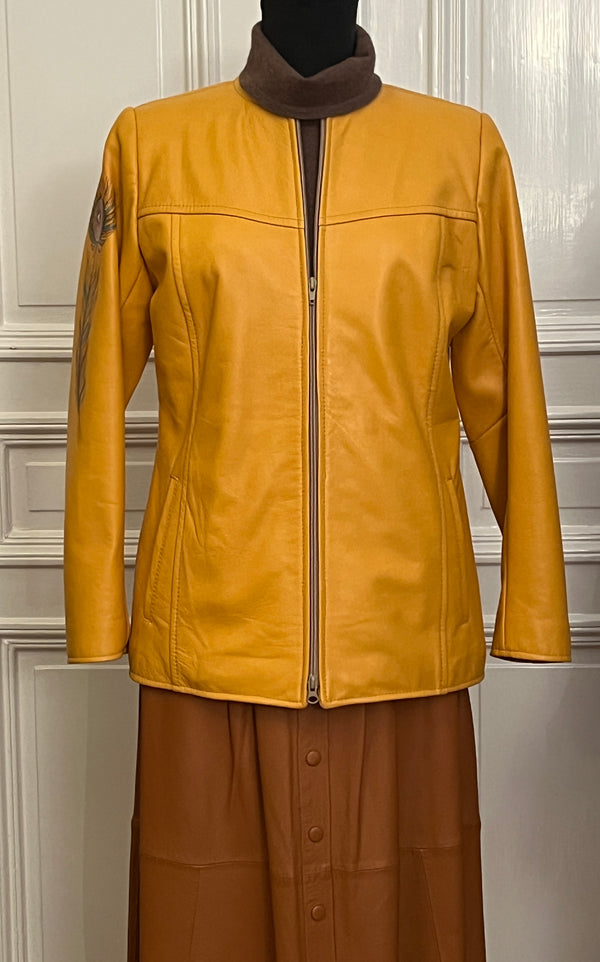 Leather jacket in yellow with a feather painted on it
